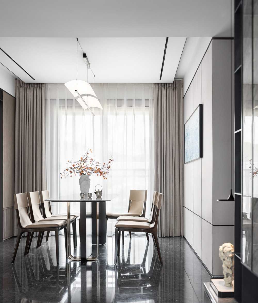 Contemporary Dining Room with Homogeneous Tiles and Artwork