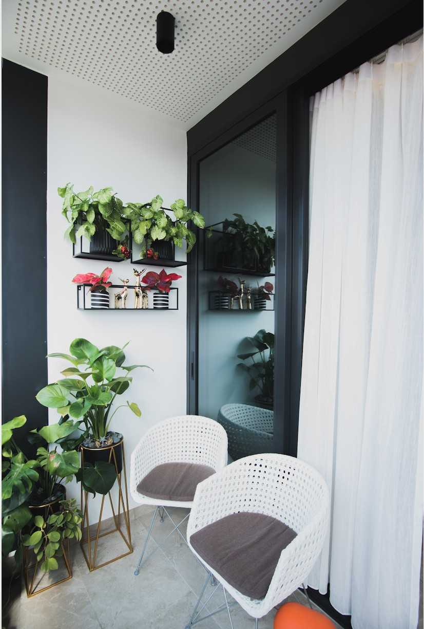 Eclectic Balcony with Outdoor Chairs and Planters