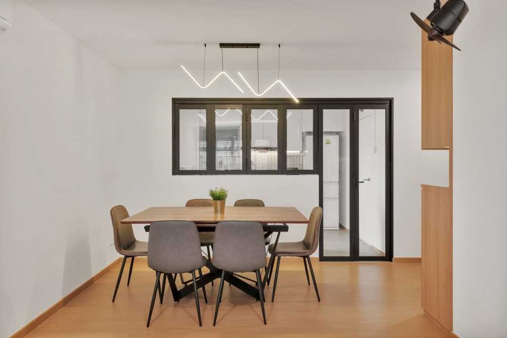 Minimalist Dining Room with Drop Light and Kitchen Window