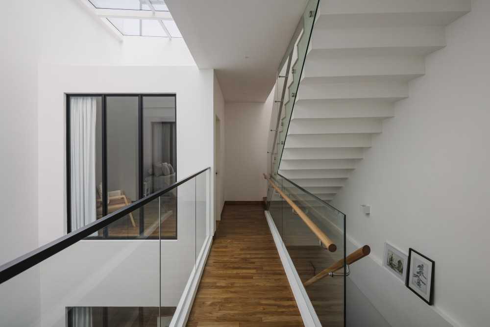 Minimalist Hallway with Parquet Floor and Staircase