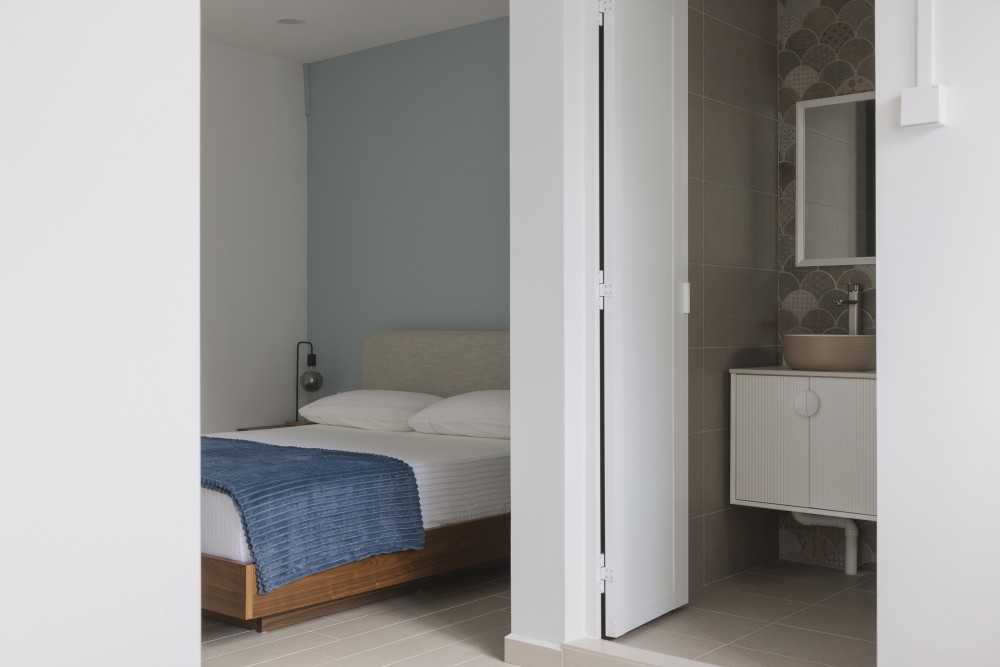 Scandinavian Bedroom with Mirror and Bathroom Storage