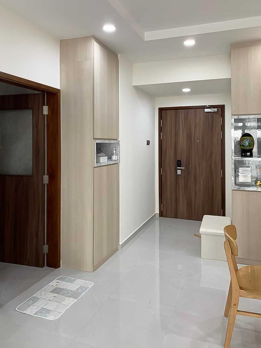 Scandinavian Foyer with Paintings and Storage Cabinets