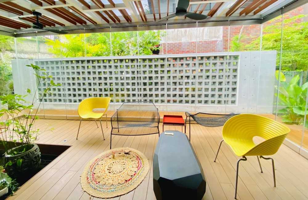 Transitional Courtyard with Wood Flooring and Feature Wall