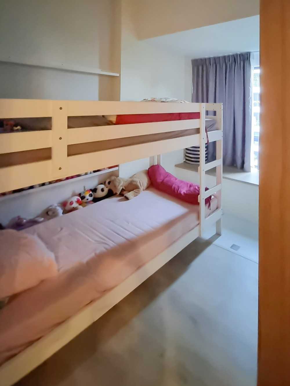 Scandinavian Bedroom with Window Seat and Paintings