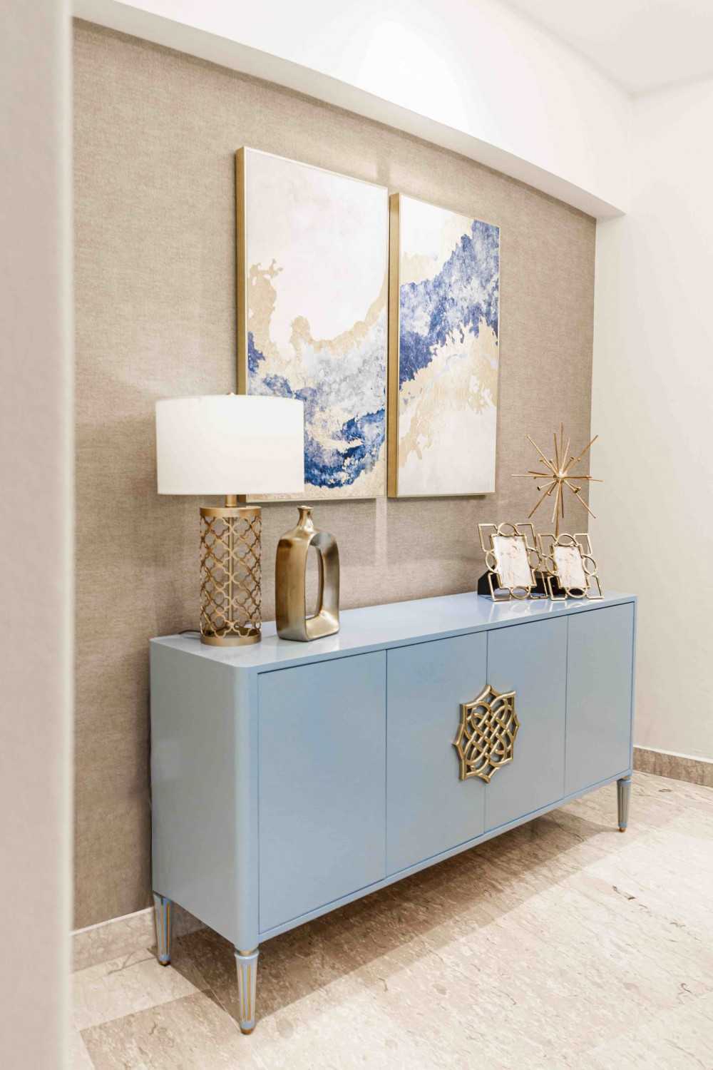 Transitional Hallway with Bookshelf and Artwork