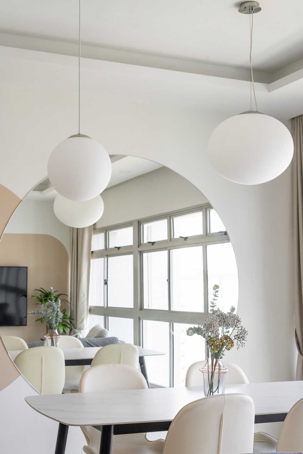 Minimalist Dining Room with Drop Light and Mirror