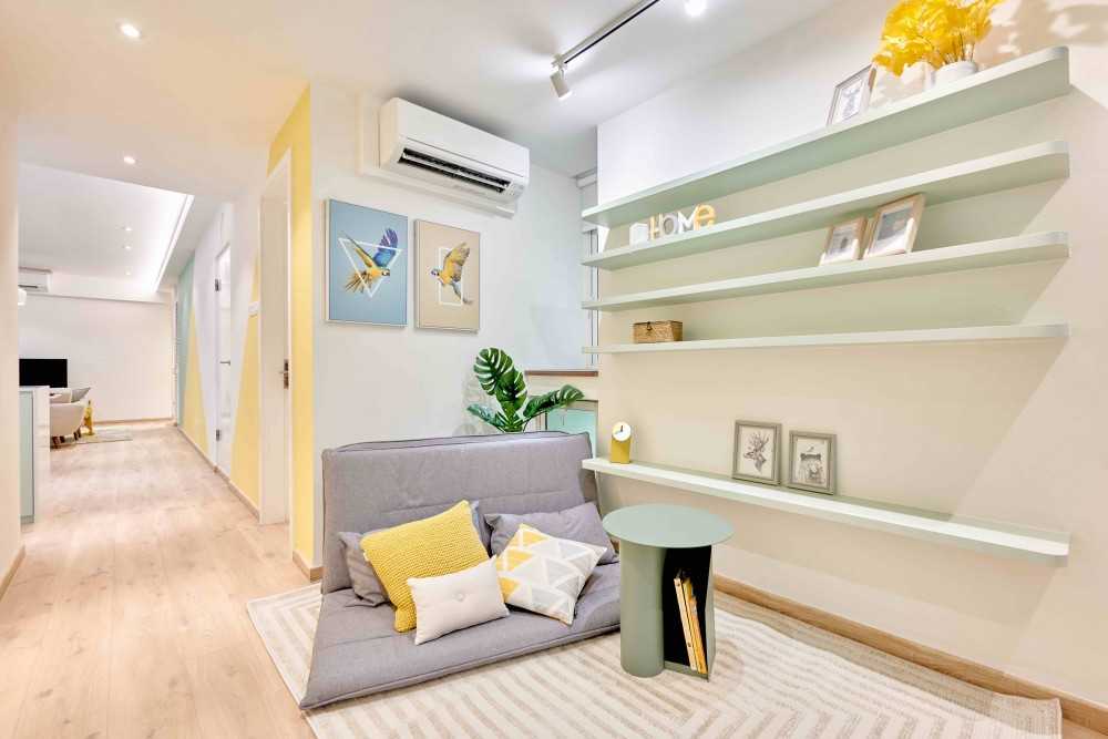 Transitional Hallway with Bookshelf and Artwork