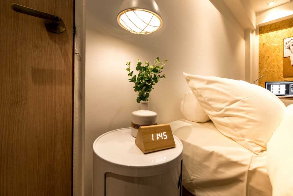 Scandinavian Bedroom with Cove Lighting and Bedside Table