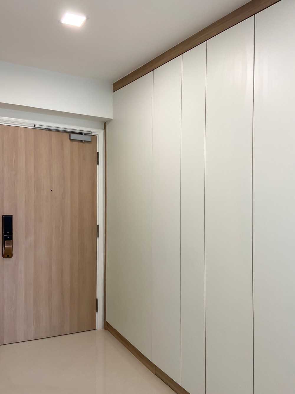 Modern Foyer with Paintings and Storage Cabinets