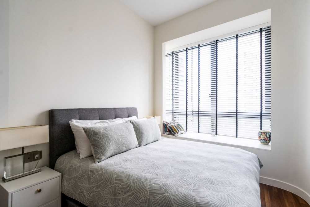 Modern Bedroom with Bay Window and Bedside Table