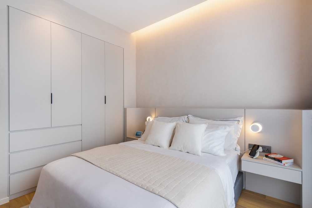 Contemporary Bedroom with Wood Flooring and Cove Lighting