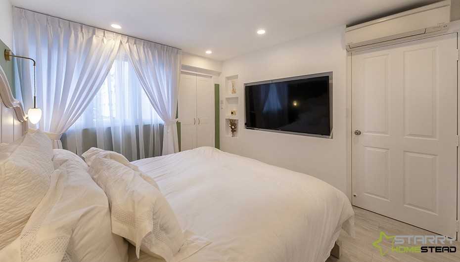Eclectic Bedroom with TV and Bed