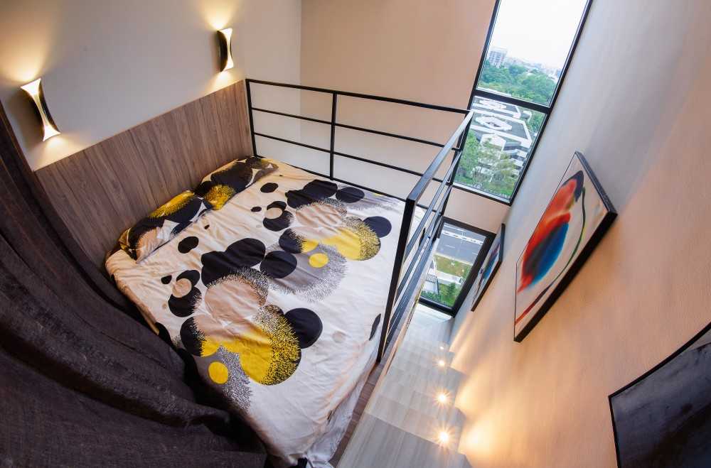 Modern Bedroom with Wood Flooring and Staircase