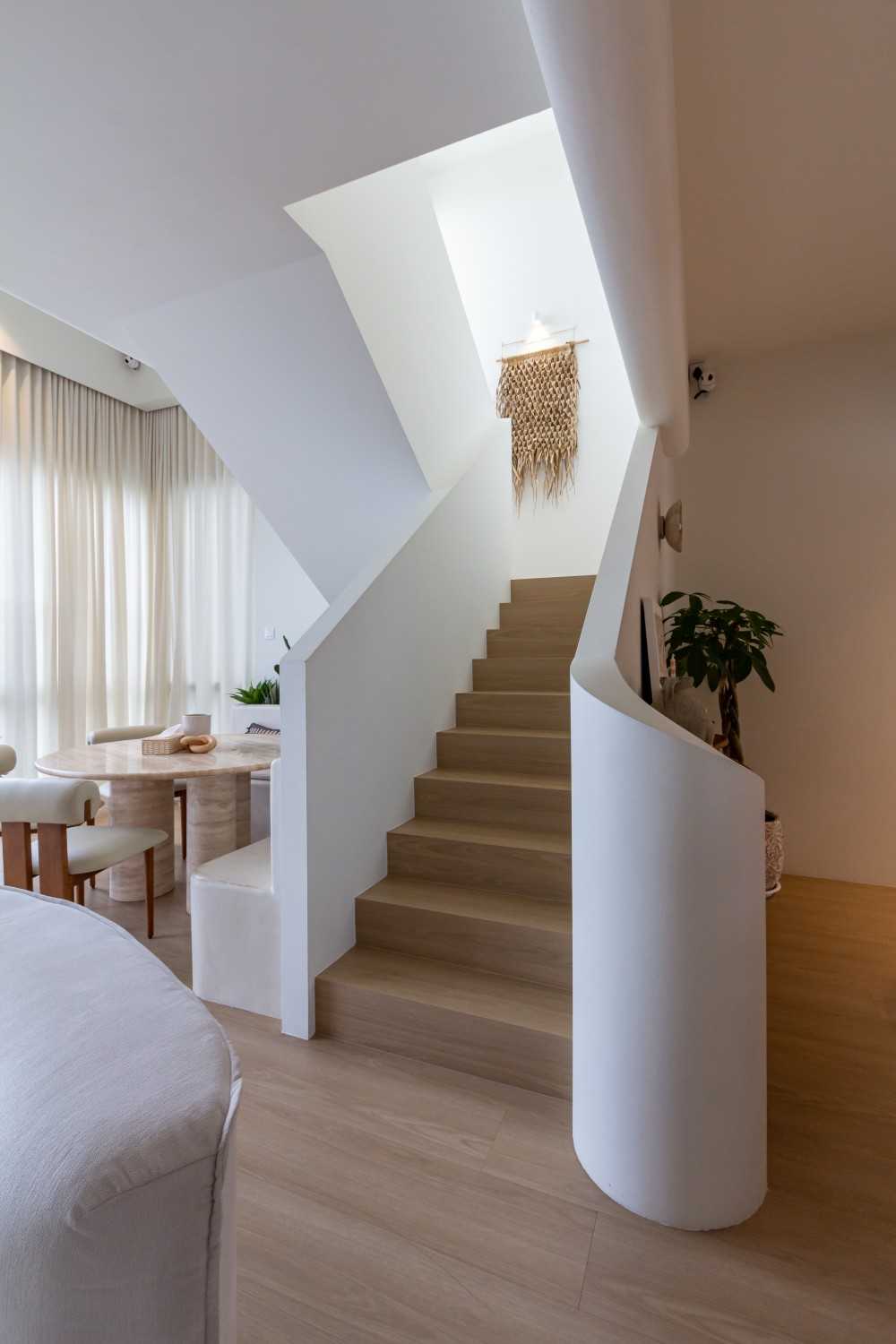Minimalist Living Room with Staircase and Dining Table