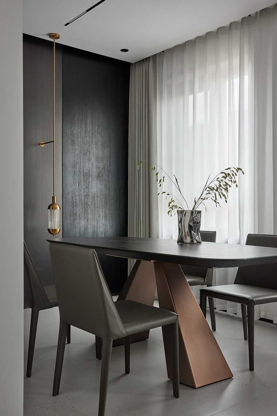 Contemporary Dining Room with Feature Wall and Drop Light