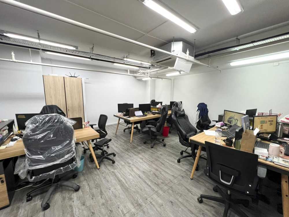 Modern Office with Paintings and Desk Chairs