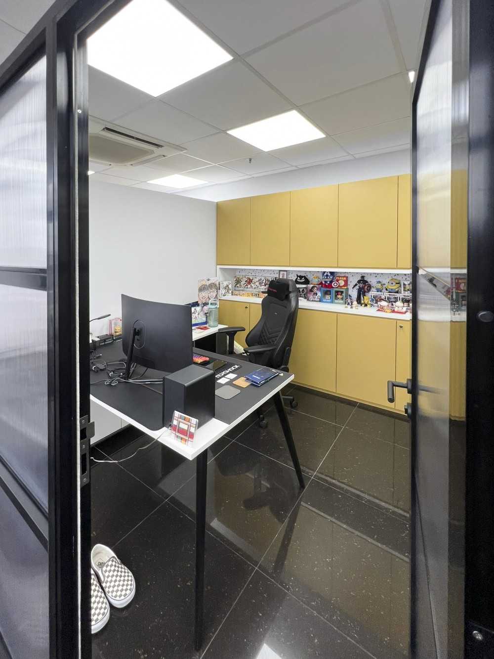 Modern Office with Glass Door and Paintings