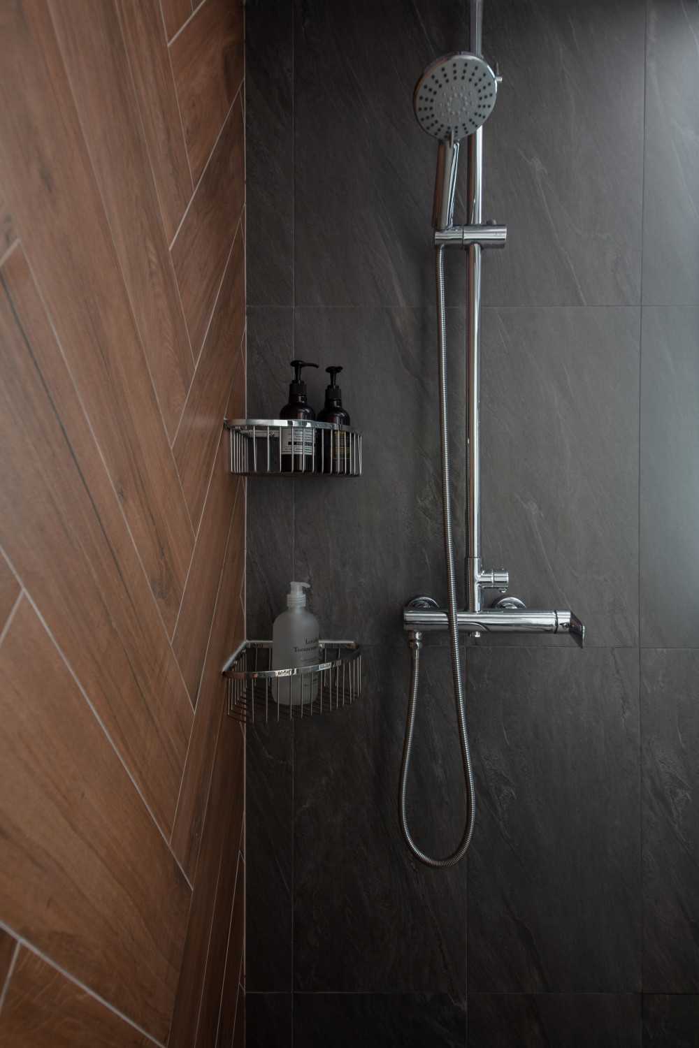 Scandinavian Bathroom with Herringbone Tiling and Showers
