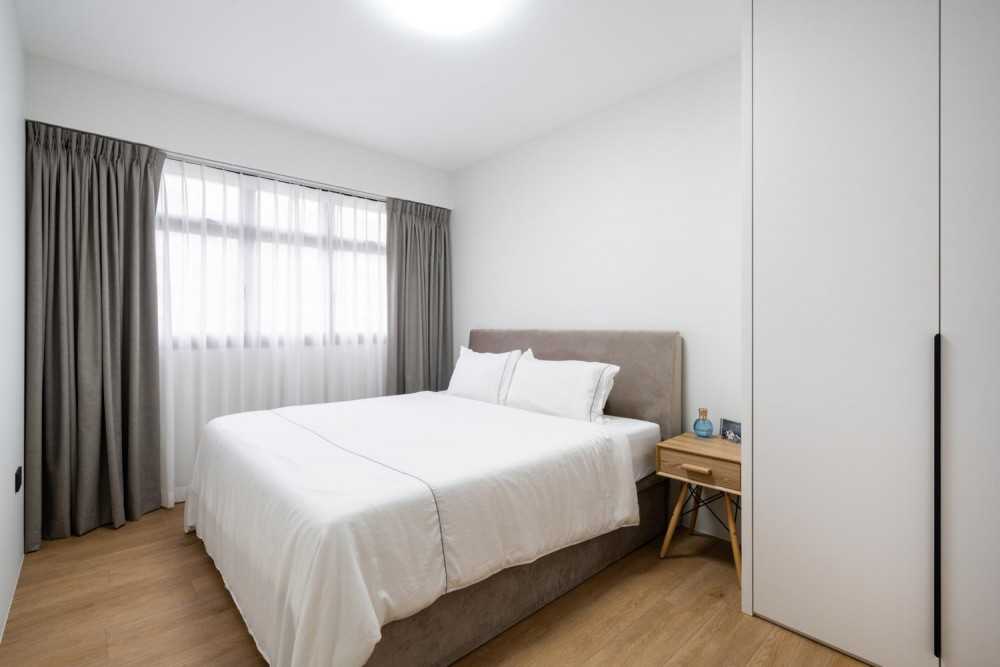 Minimalist Bedroom with Bookshelf and Ceiling Light