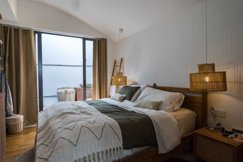 Scandinavian Bedroom with Wood Flooring and Queen Bed