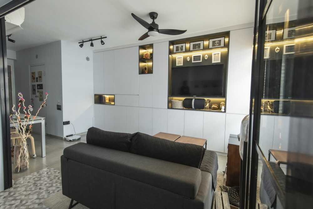 Modern Living Room with Bookshelf and Homogeneous Tiles