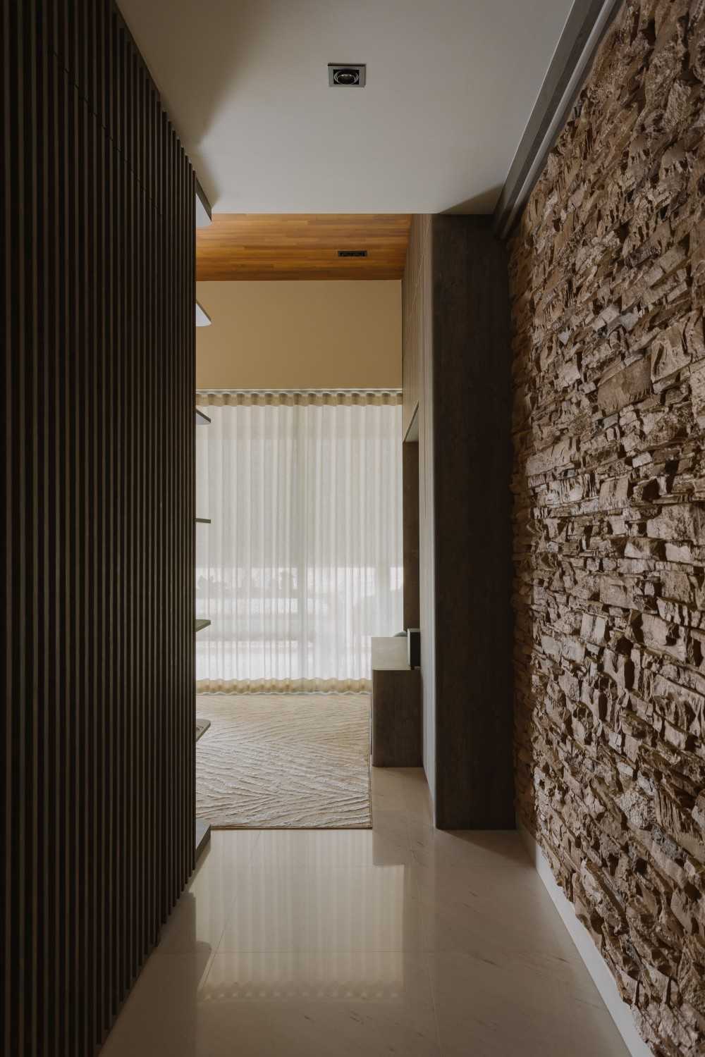 Minimalist Entryway with TV Console and Feature Wall