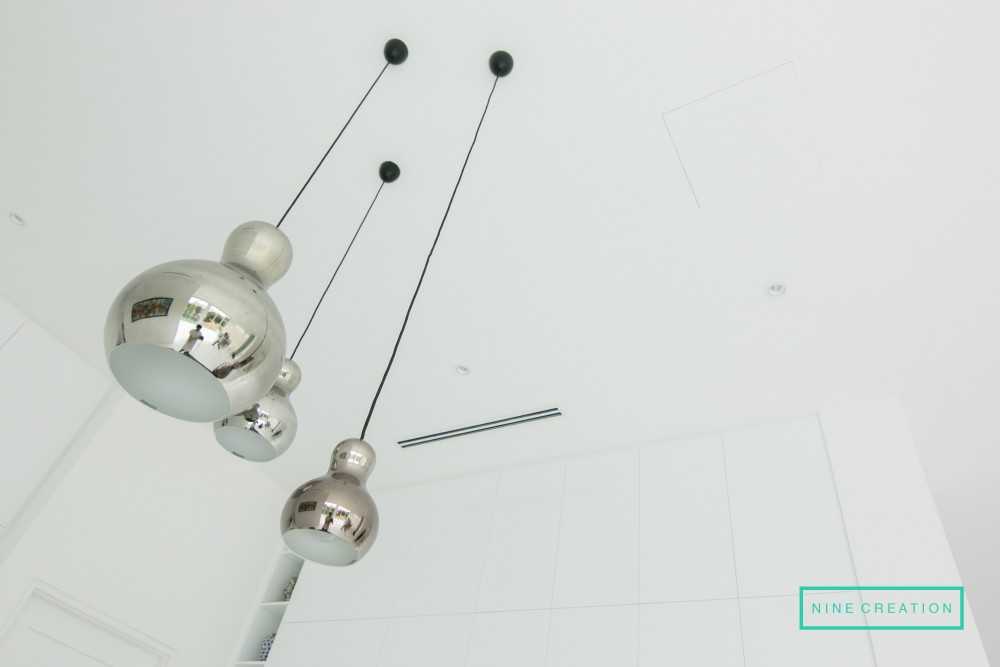 Contemporary Dining Room with Drop Light and Downlights