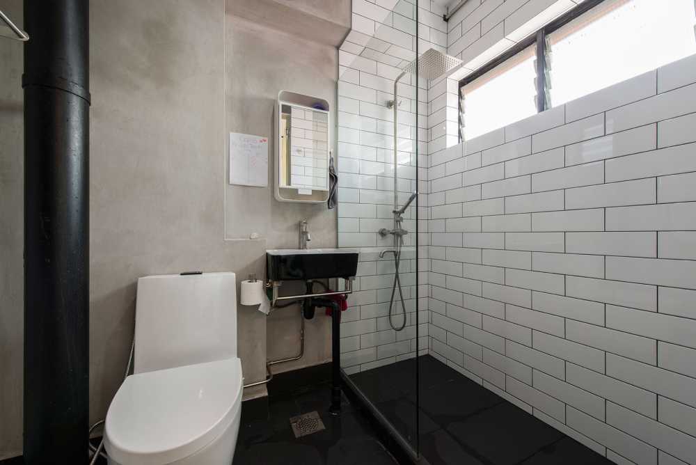 Industrial Bathroom with Homogeneous Tiles and Mirror