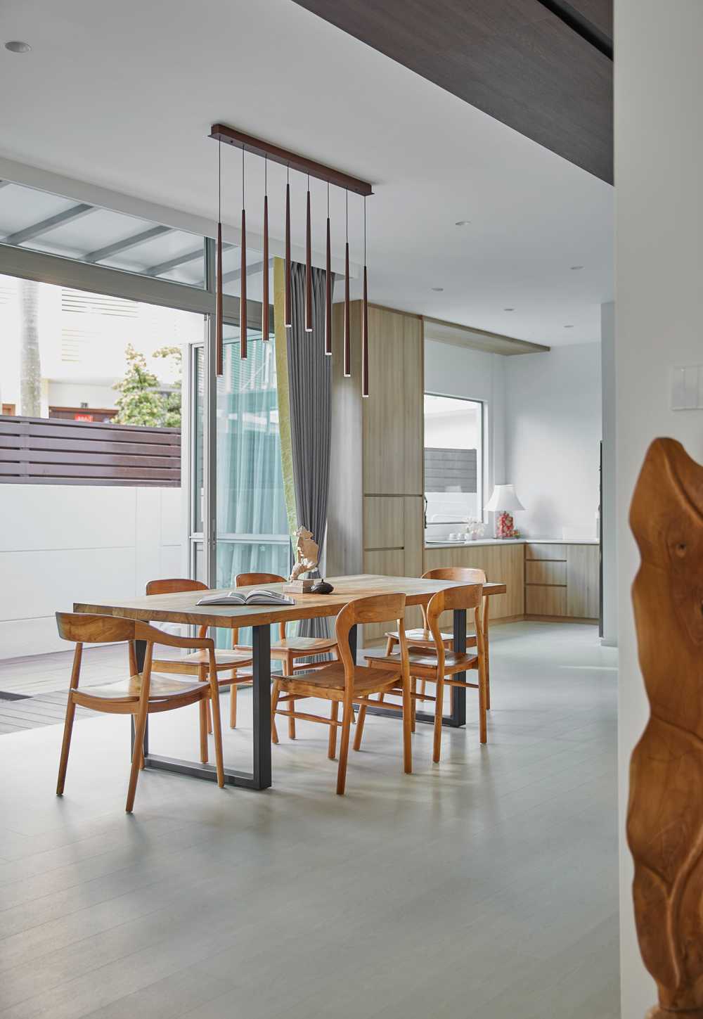 Scandinavian Dining Room with Glass Door and Paintings