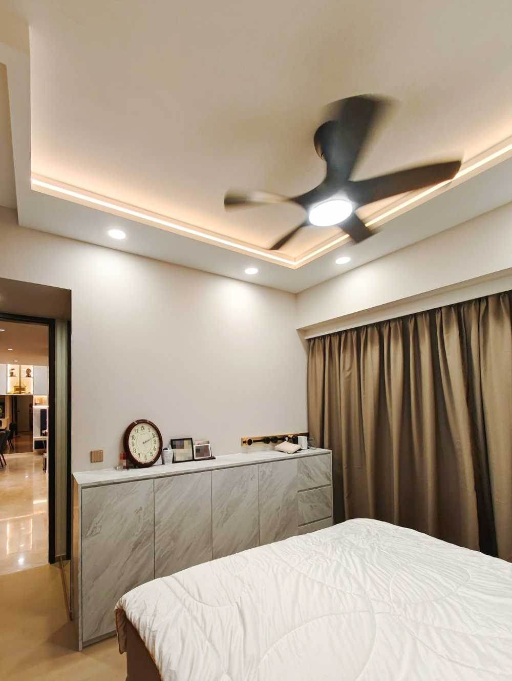 Scandinavian Bedroom with Ceiling Fan and Paintings