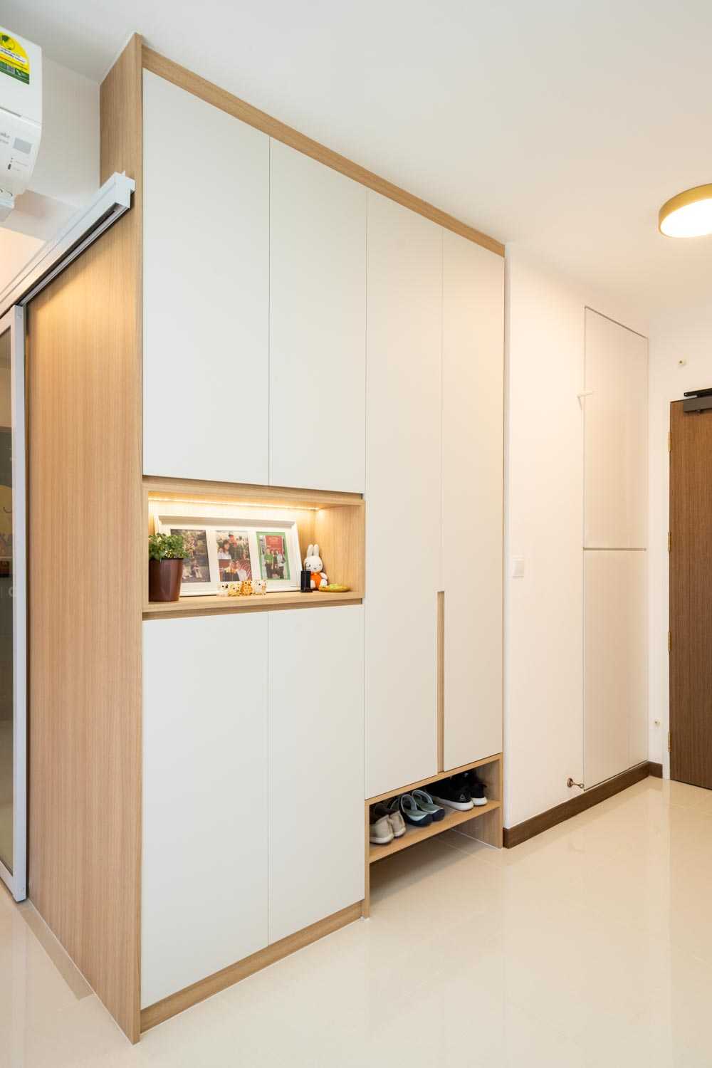 Contemporary Foyer with Artwork and Shoe Rack