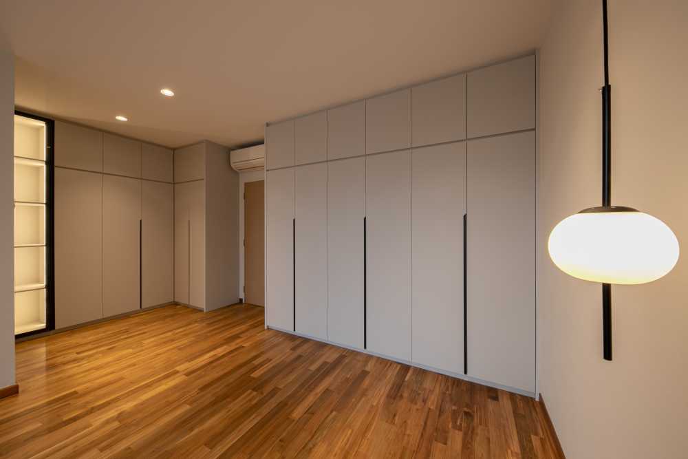 Minimalist Bedroom with Parquet Floor and Drop Light
