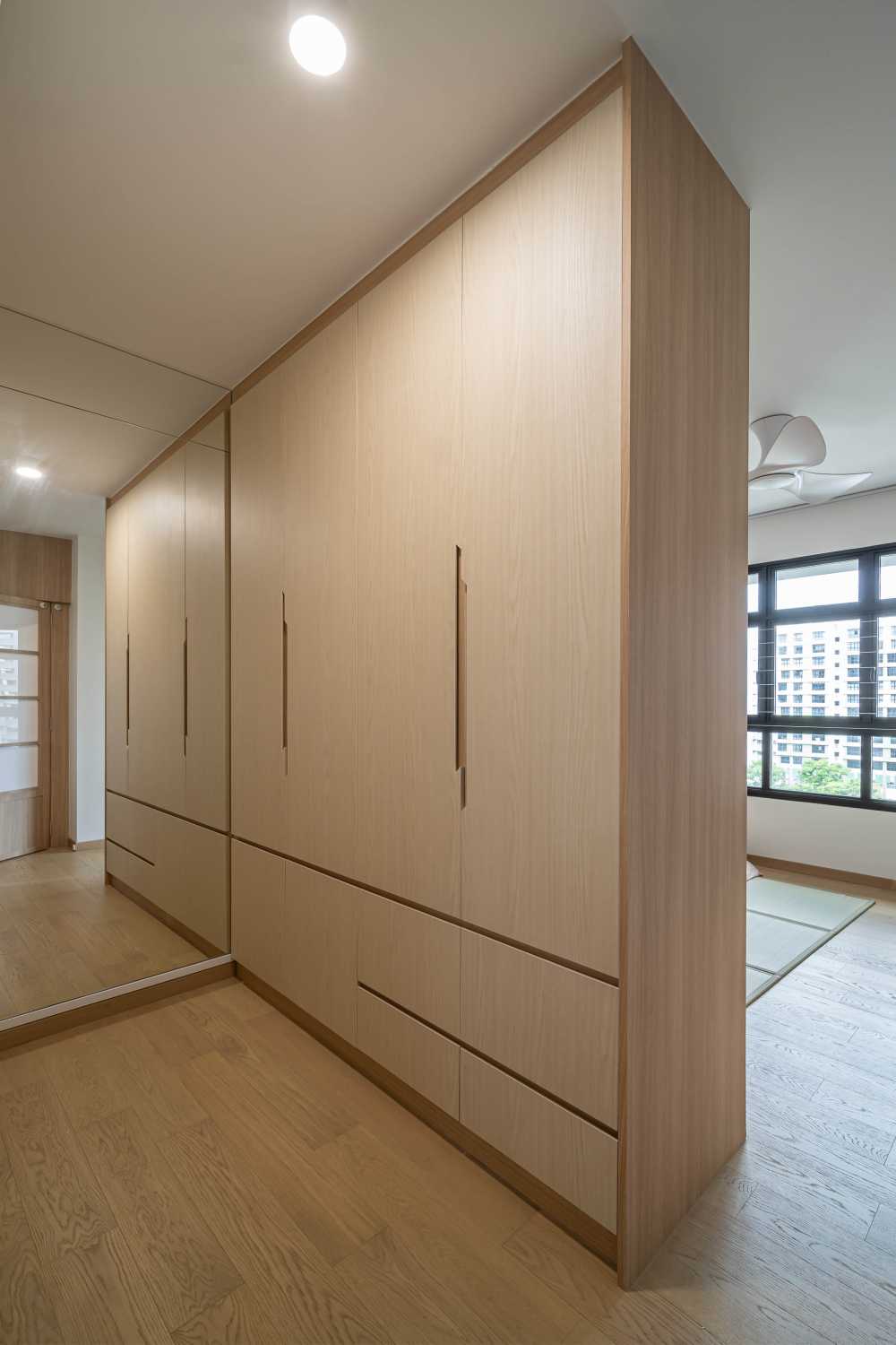 Asian Bedroom with Wood Flooring and Mirror