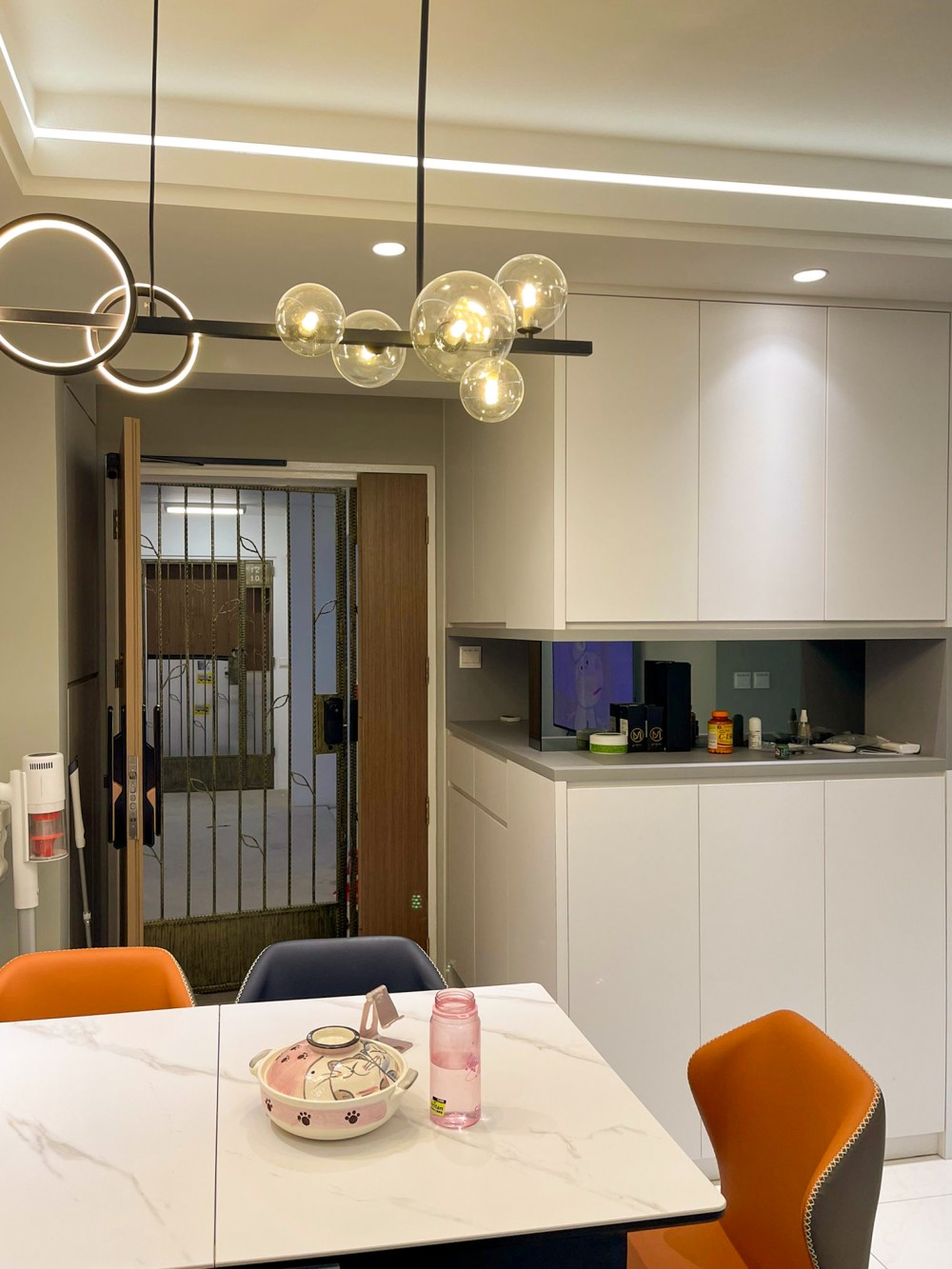 Minimalist Dining Room with TV Console and Cove Lighting