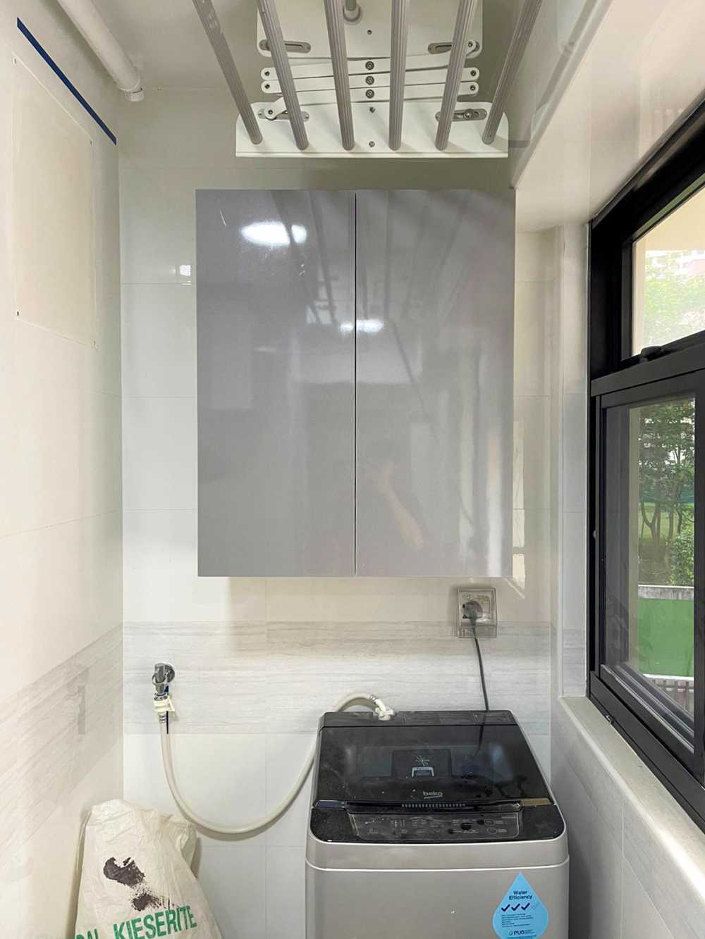 Minimalist Service Yard with Washing Machine and Laundry Area