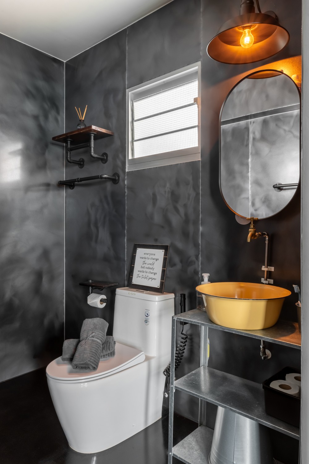 Industrial Bathroom with Homogeneous Tiles and Mirror