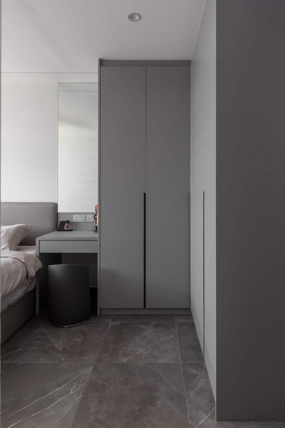 Minimalist Bedroom with Homogeneous Tiles and Wardrobe