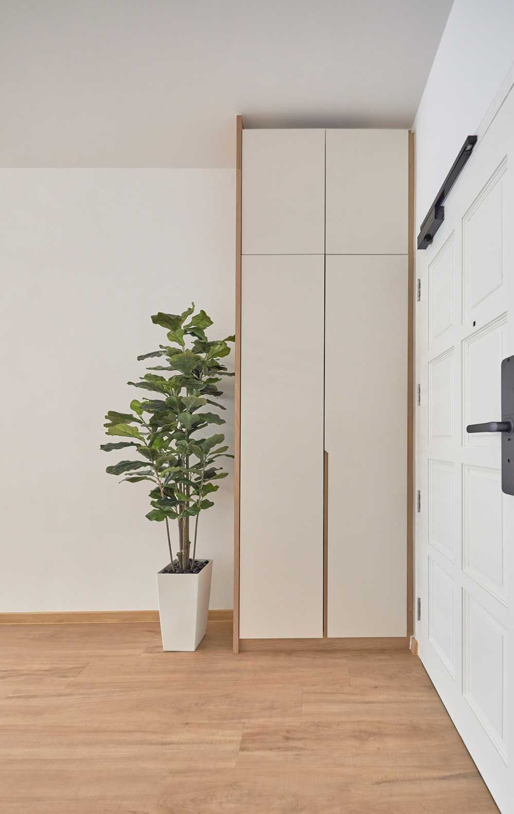 Scandinavian Foyer with Paintings and Storage Cabinets