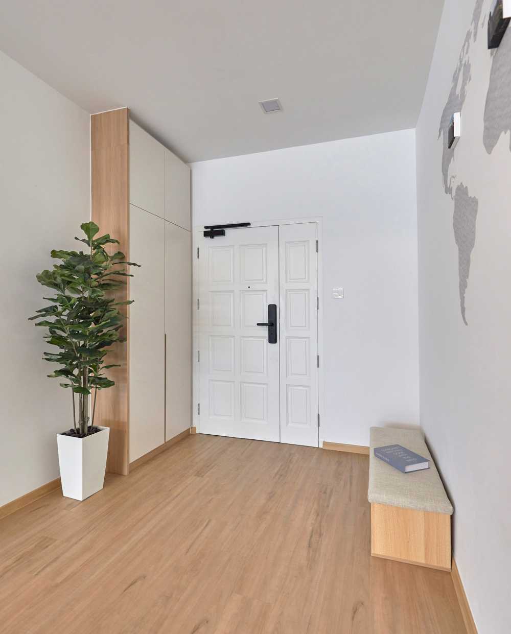 Scandinavian Foyer with Paintings and Shoe Cabinets