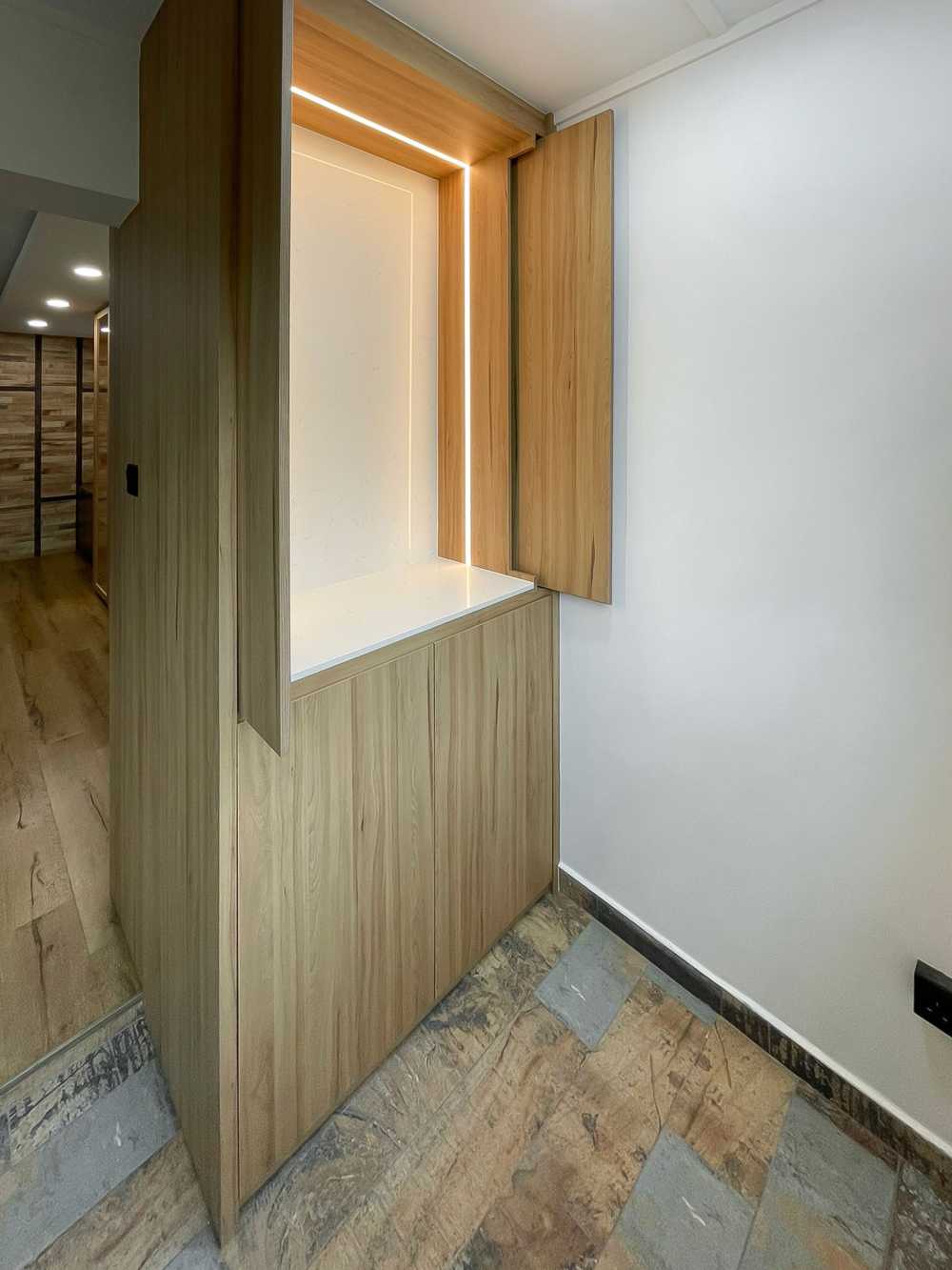 Scandinavian Entryway with Paintings and Storage Cabinets