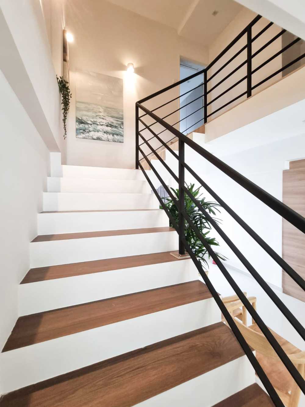 Scandinavian Hallway with Staircase and Paintings