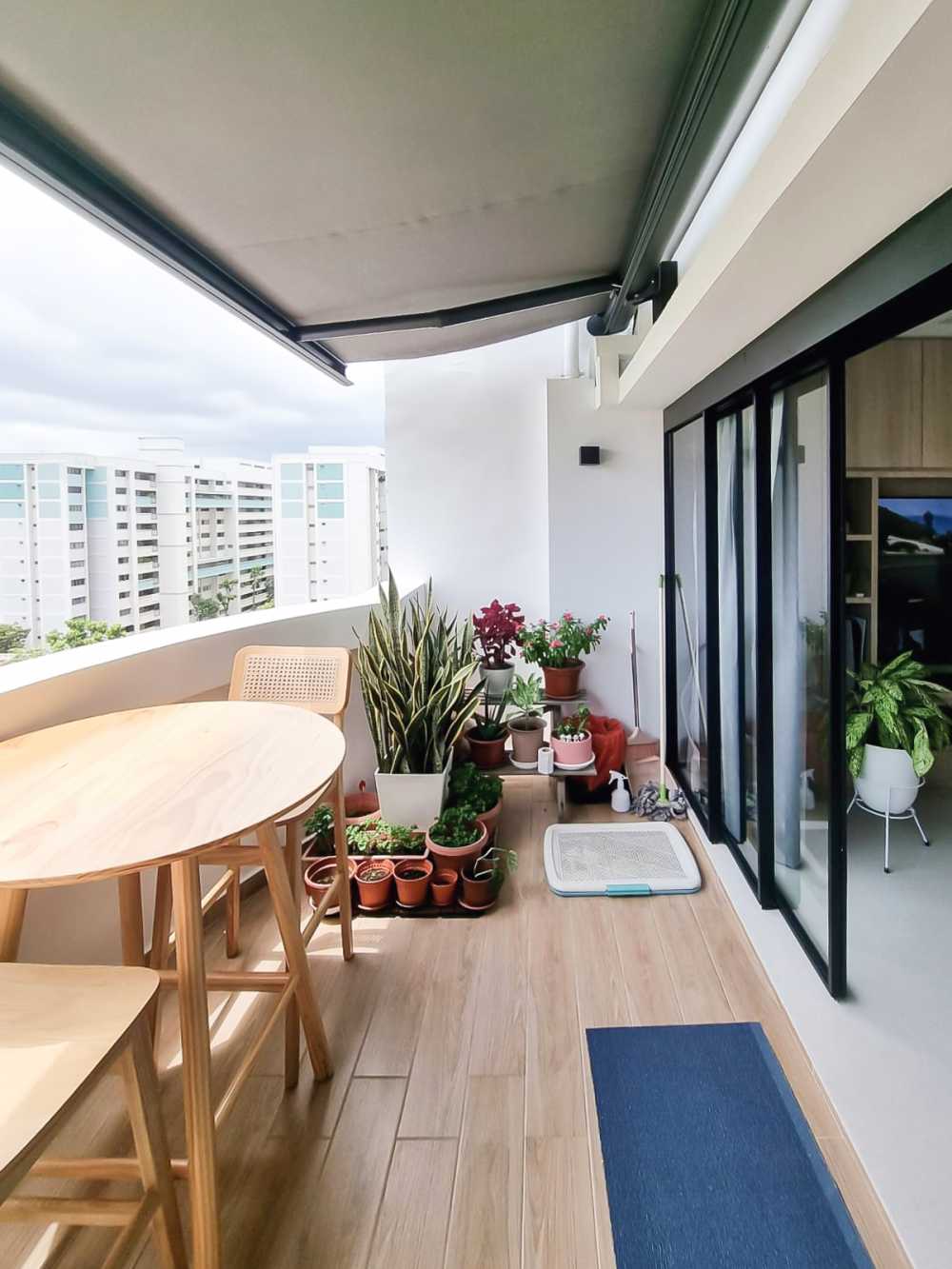 Scandinavian Balcony with Glass Door and Paintings