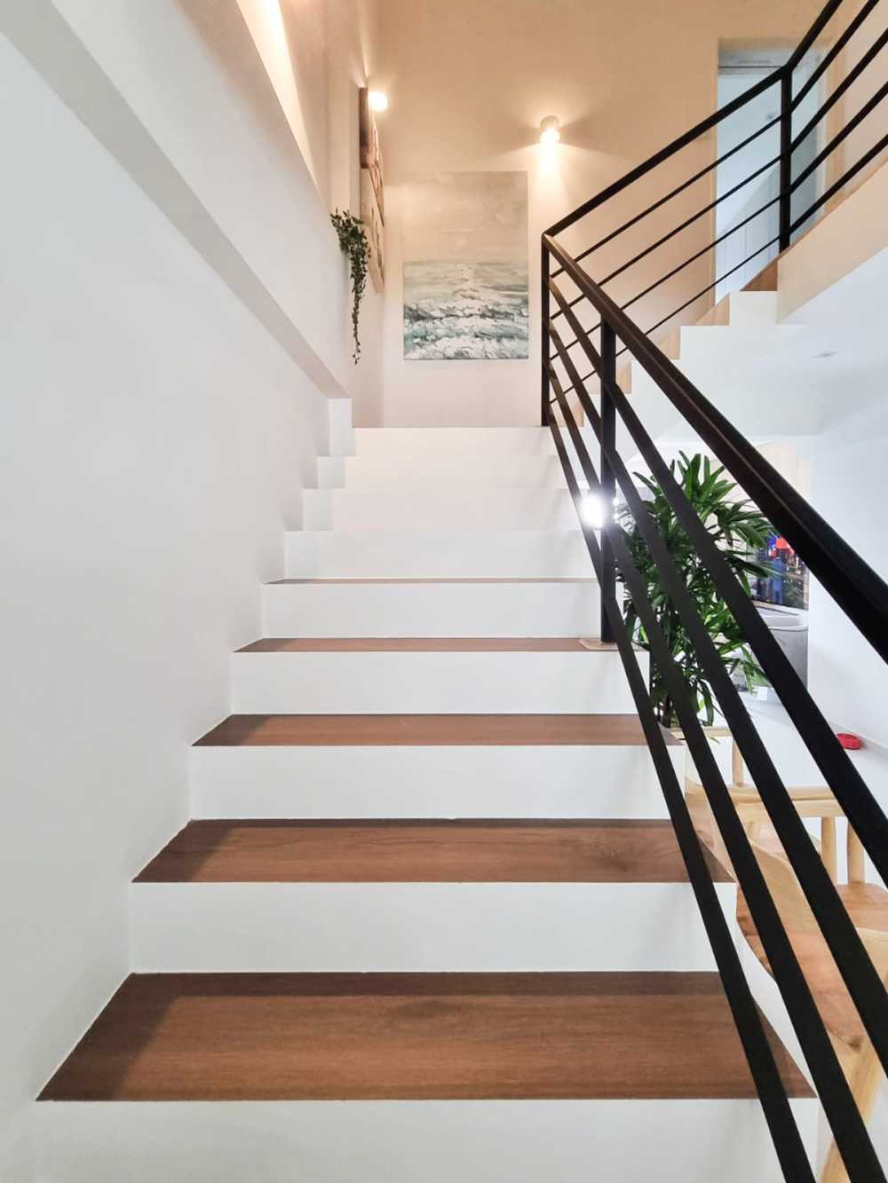Scandinavian Hallway with Staircase and Paintings