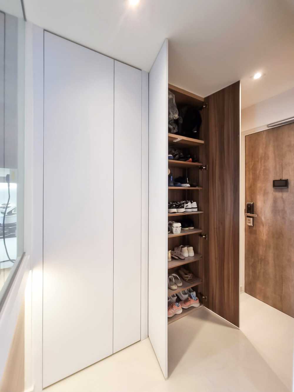 Scandinavian Foyer with Paintings and Storage Cabinets