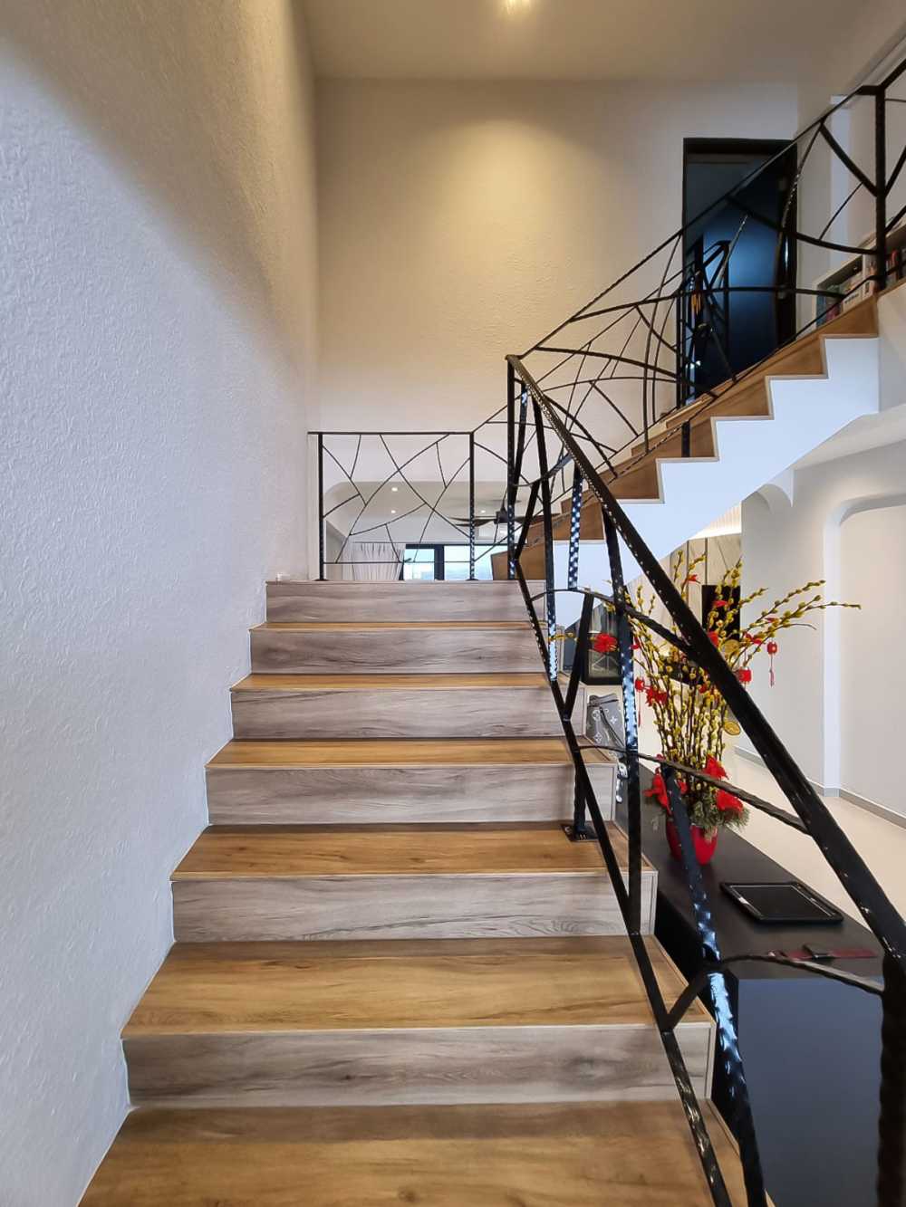 Scandinavian Hallway with Staircase and Paintings