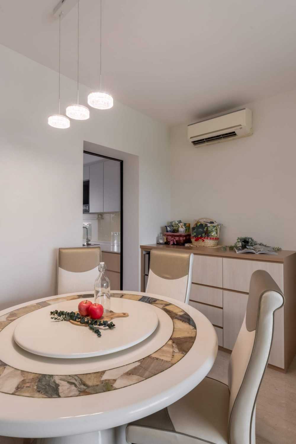 Minimalist Dining Room with Drop Light and Chandelier