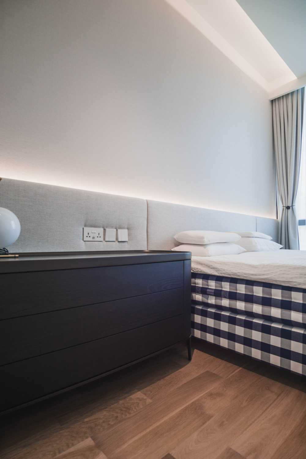 Minimalist Bedroom with Wood Flooring and Bedside Table