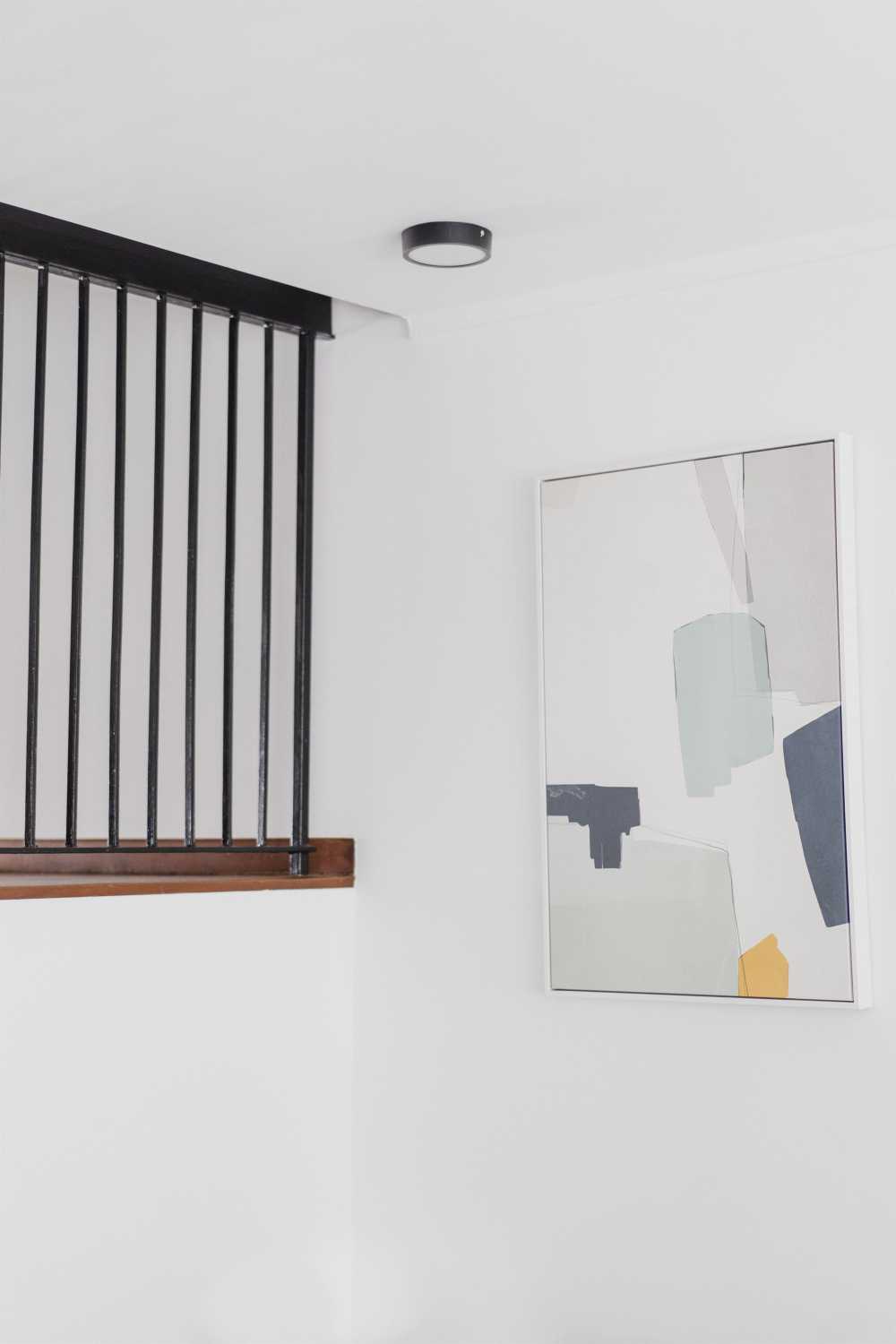 Contemporary Entryway with Ceiling Light and Paintings