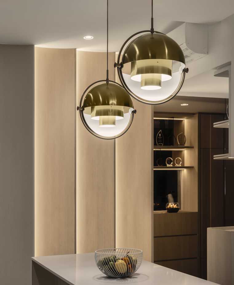 Modern Dining Room with Drop Light and Storage Cabinets