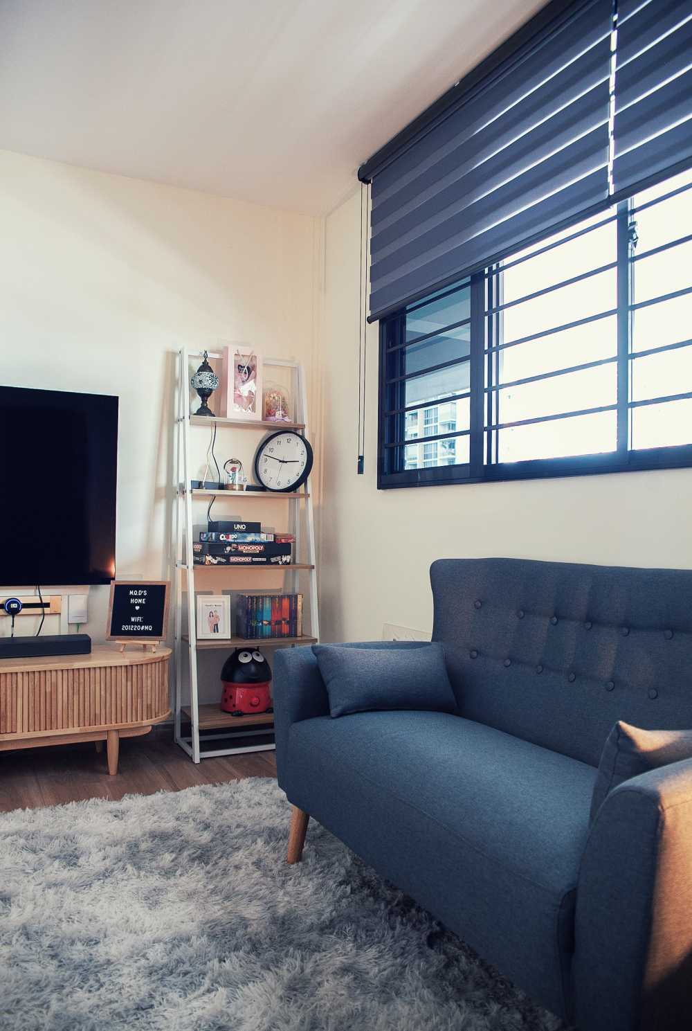 Scandinavian Living Room with Bookshelf and Homogeneous Tiles